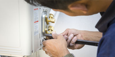 Technician Repairing Air Conditioner